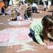 Carlee Spagnoli, 5, uses chalk to draw during the Promoting Ethnic And Cultural Equality Day on Sunday. Daniel Brenner I AnnArbor.com